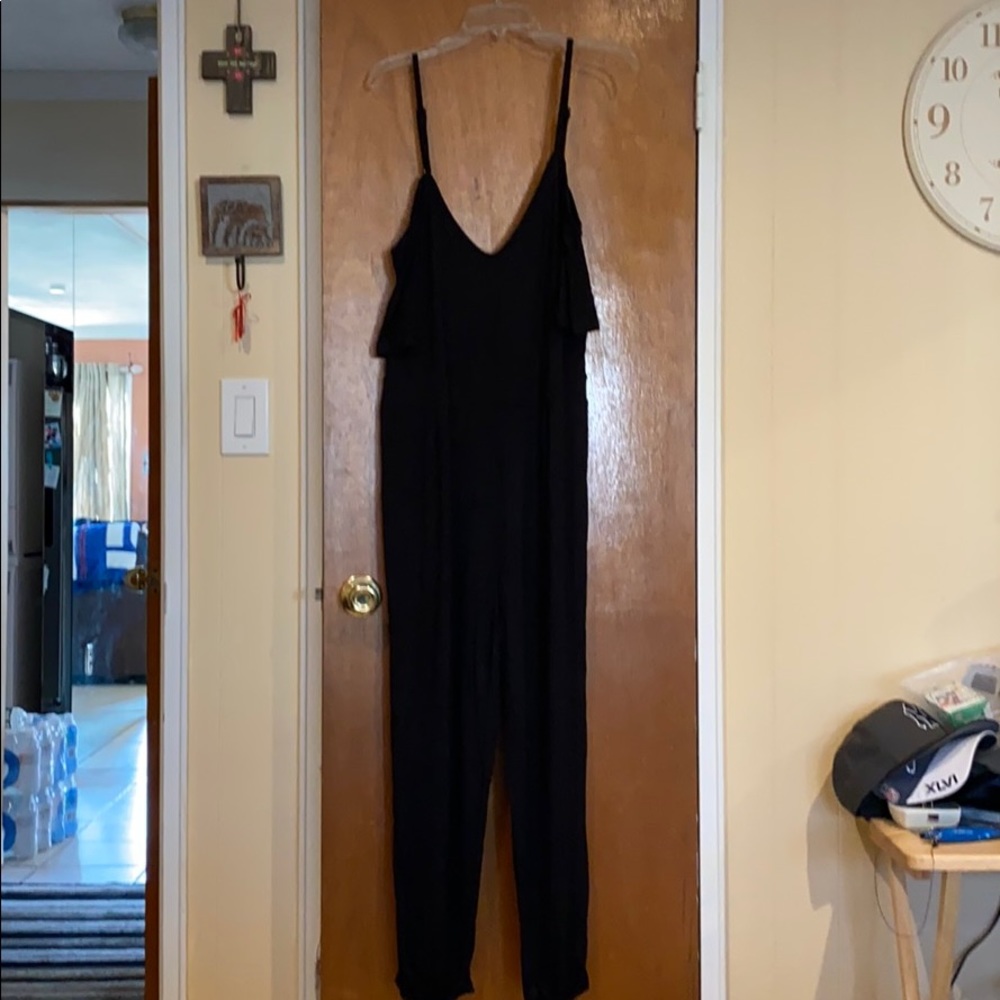 Black stretchy jumpsuit with adjustable straps.